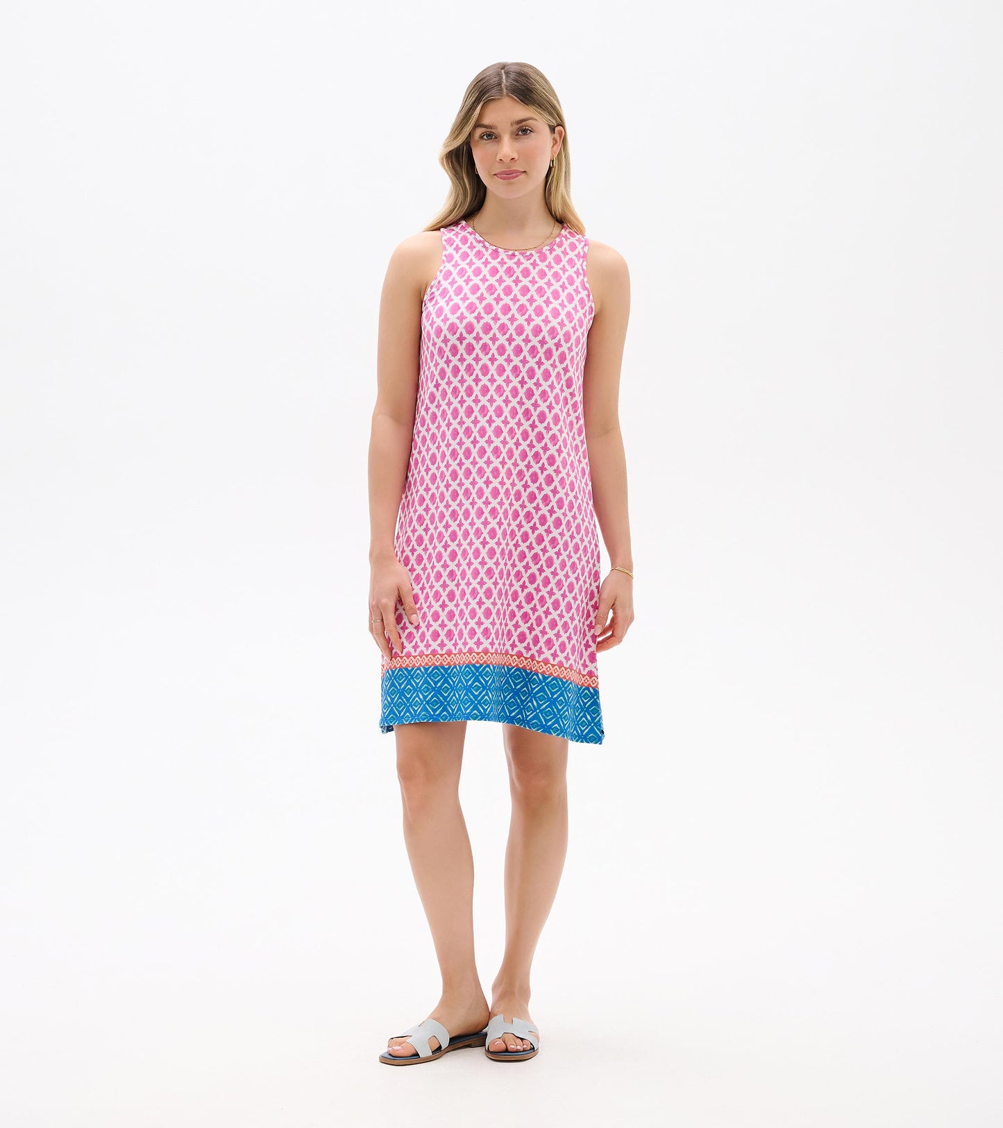 Sleeveless pink patterned shift dress with blue hem, shown on model front view