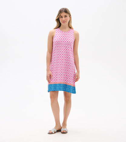 Sleeveless pink patterned shift dress with blue hem, shown on model front view