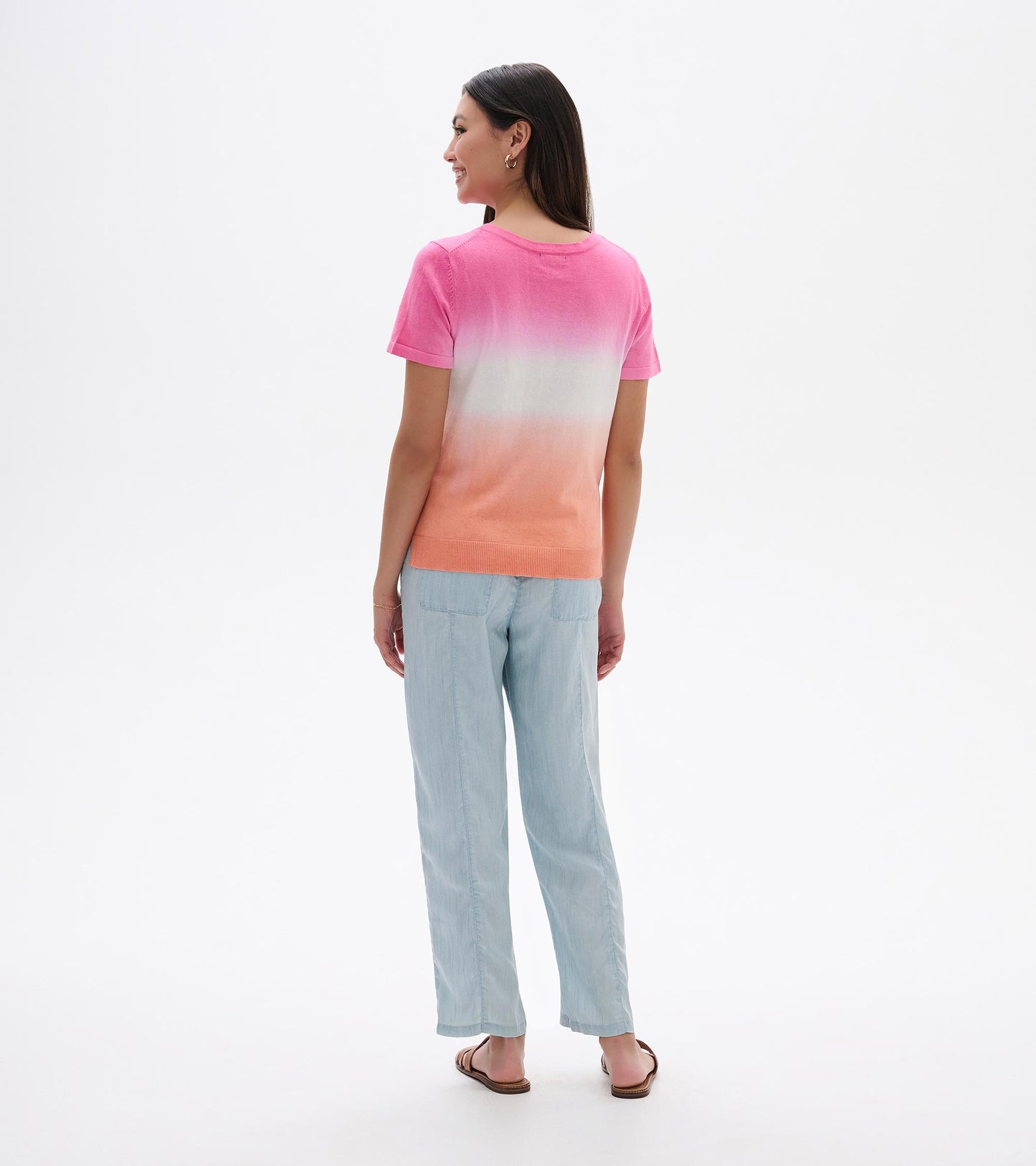 Back view of a pink-to-coral dip-dye knit tee with short sleeves and ribbed hem