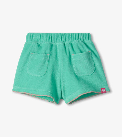 Mint green toddler shorts with elastic waistband, front pockets, and pink trim, front view