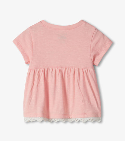 Pink short-sleeve toddler T-shirt with gathered hem and white lace trim, back view