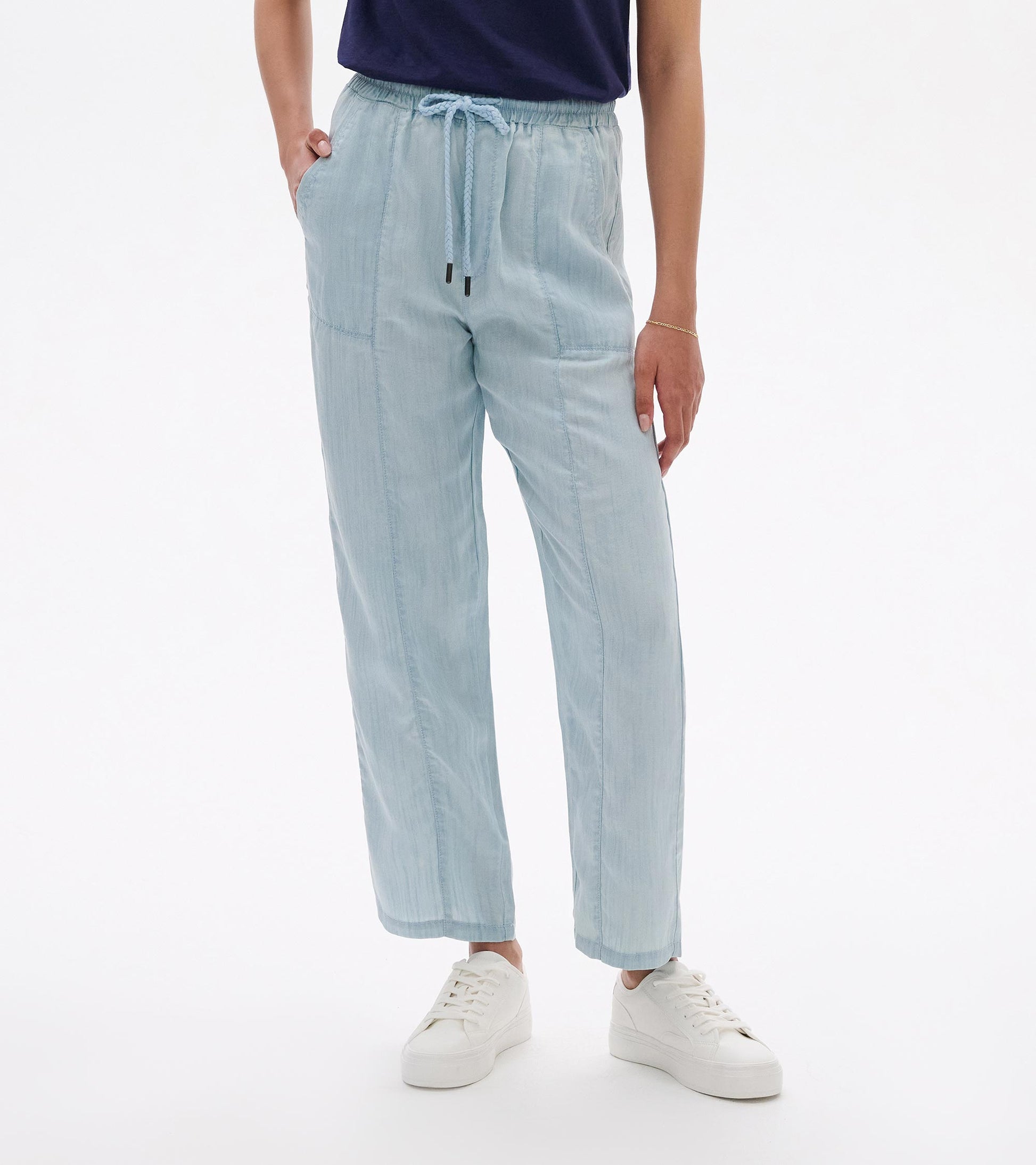 Light blue straight-leg pants with elastic waist and drawstring, shown on a model with front view