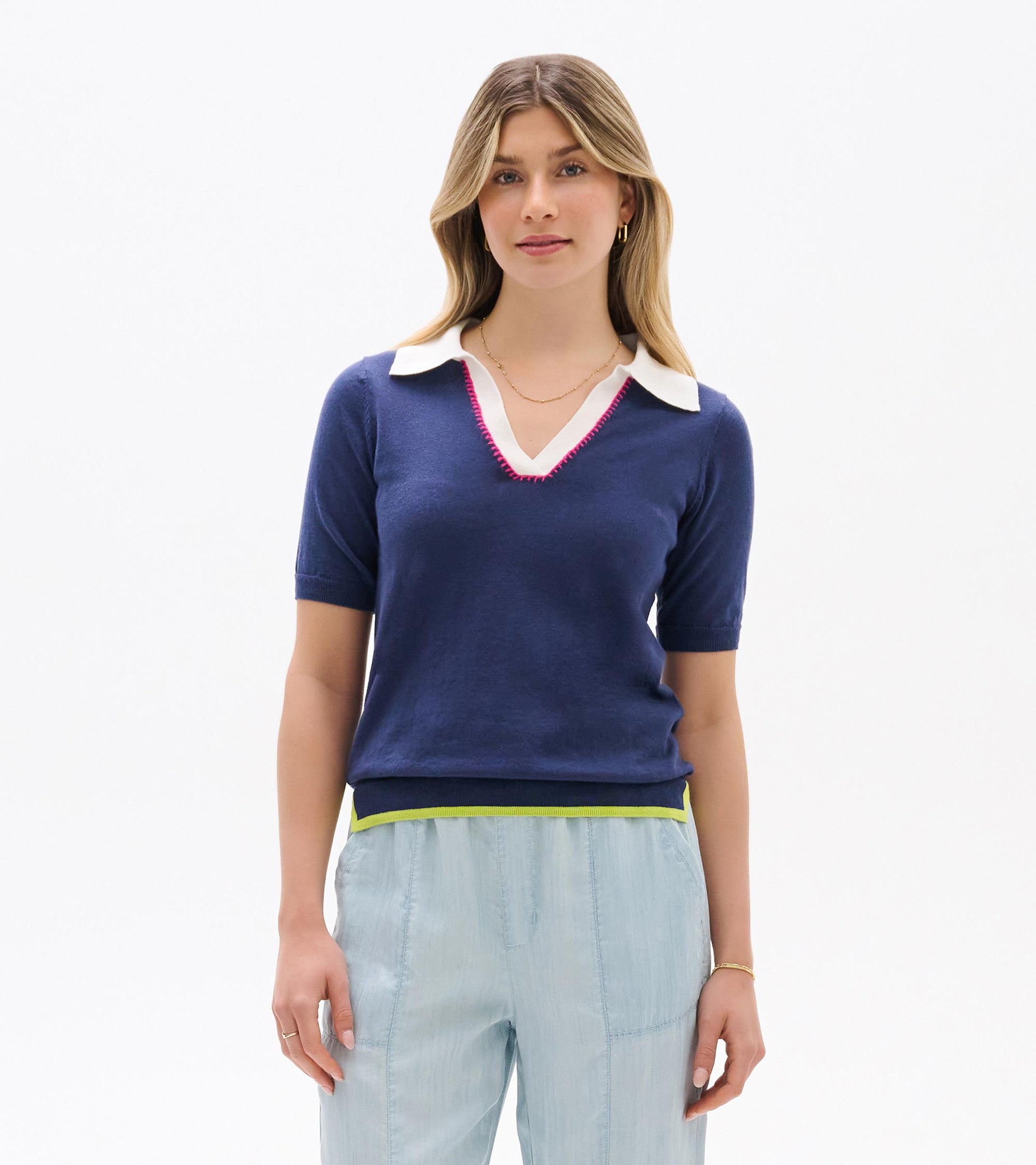 Navy short-sleeve knit top with white Johnny collar, V-neck, pink trim, and lime hem, front view.
