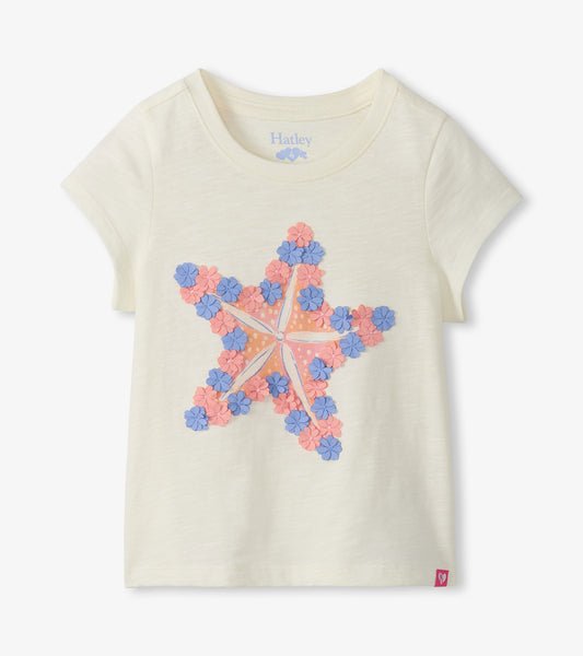 Cream short-sleeve girls tee with a large pink and blue starfish graphic on the front