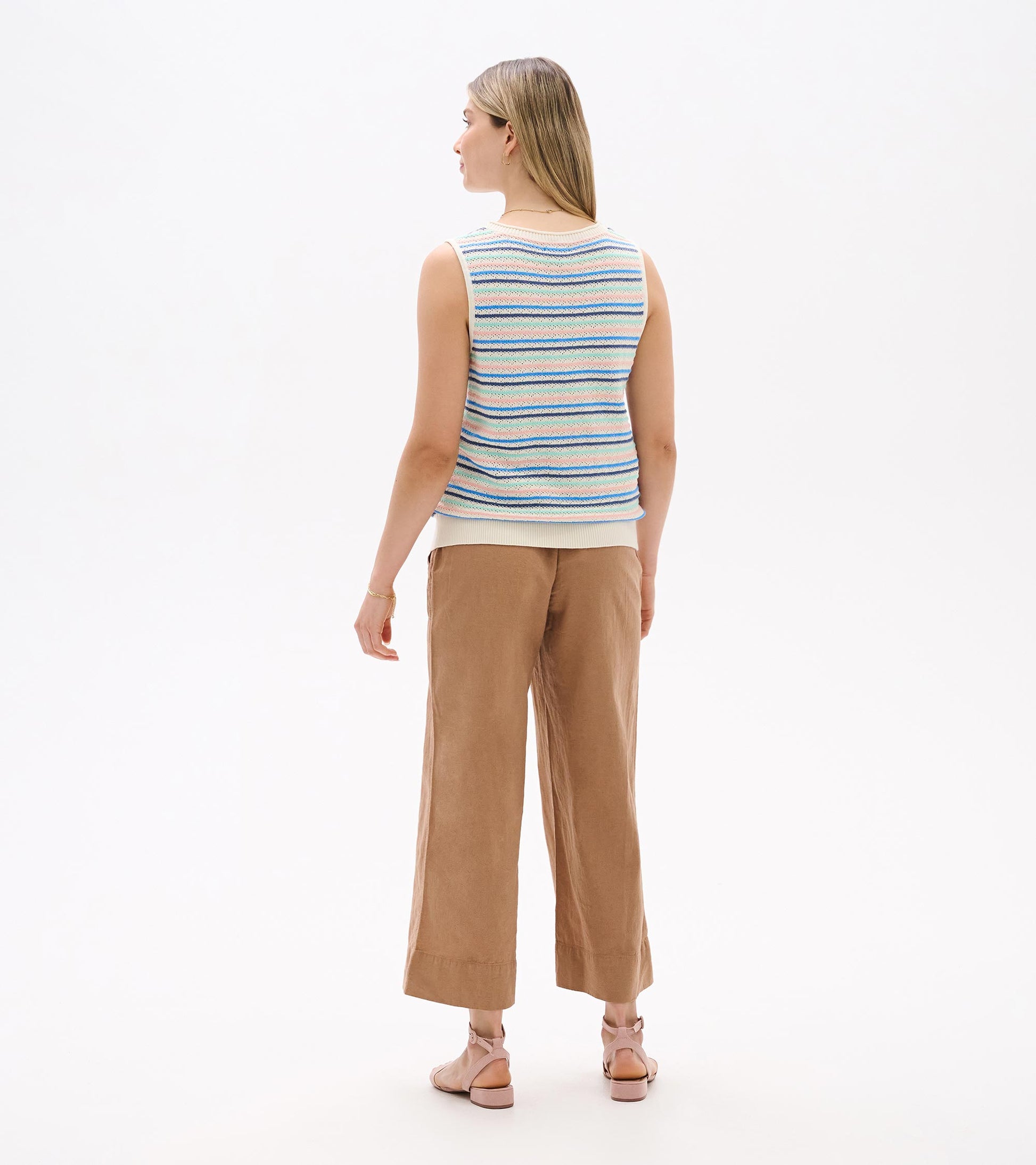 Back view of sleeveless knit tank with cream base and blush, aqua, and blue horizontal stripes
