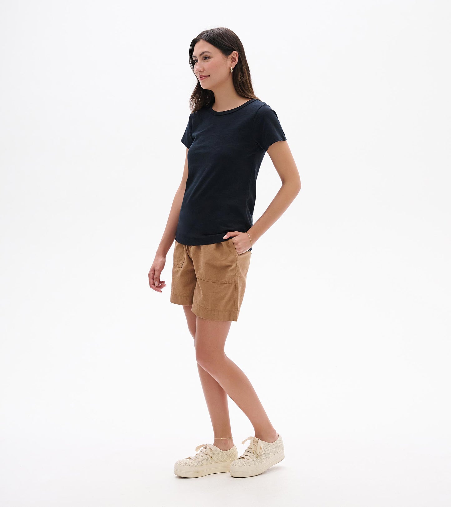 Woman wearing a black crew neck short-sleeve tee, shown front view with a fitted silhouette.