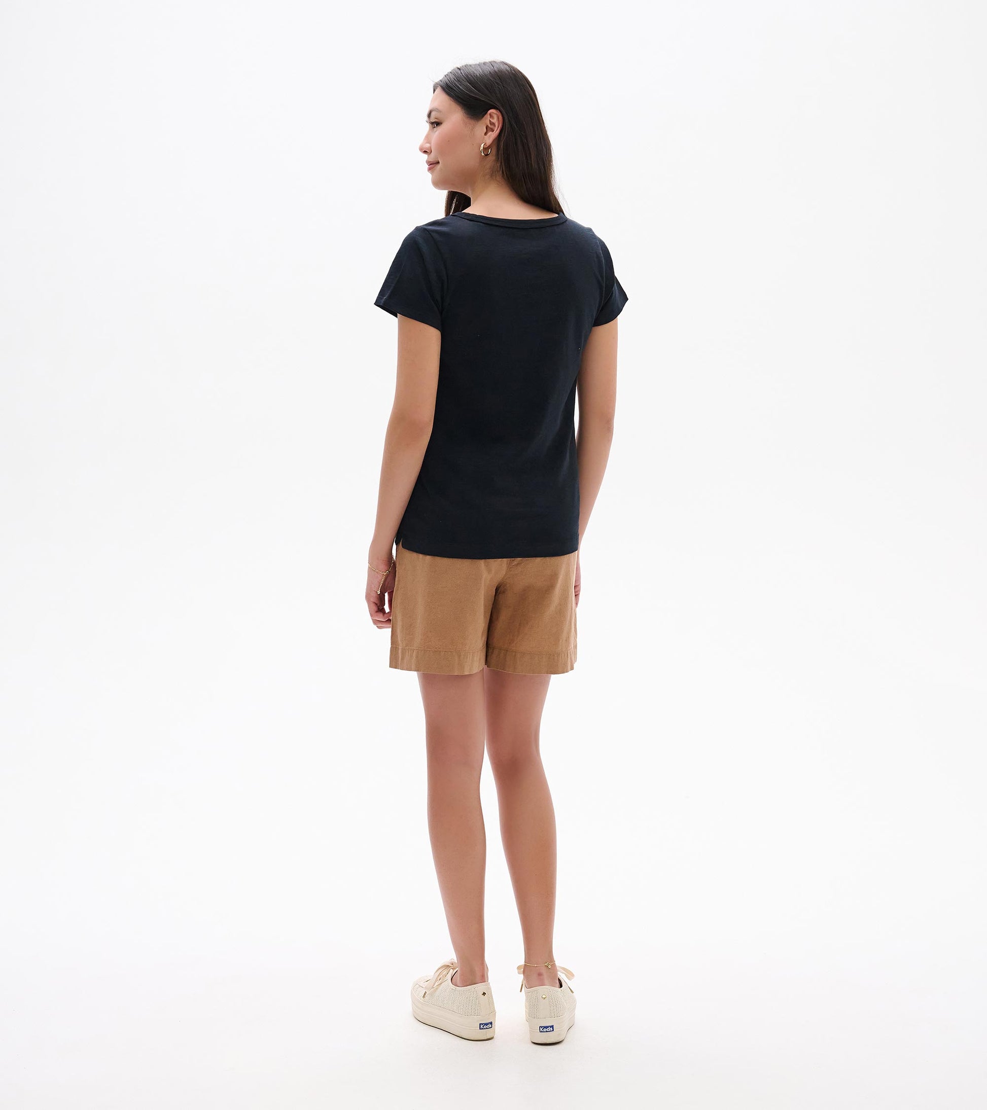 Back view of a black crew neck short-sleeve tee on a model, with a slim fit and straight hem
