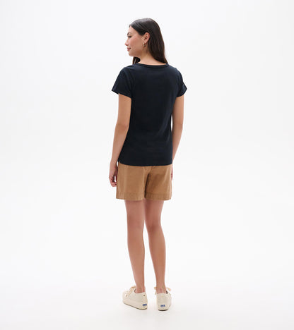Back view of a black crew neck short-sleeve tee on a model, with a slim fit and straight hem