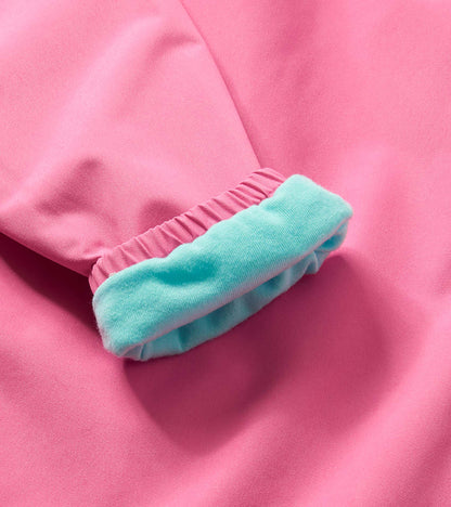 Pink microfiber rain jacket sleeve with aqua cuff detail, close-up view