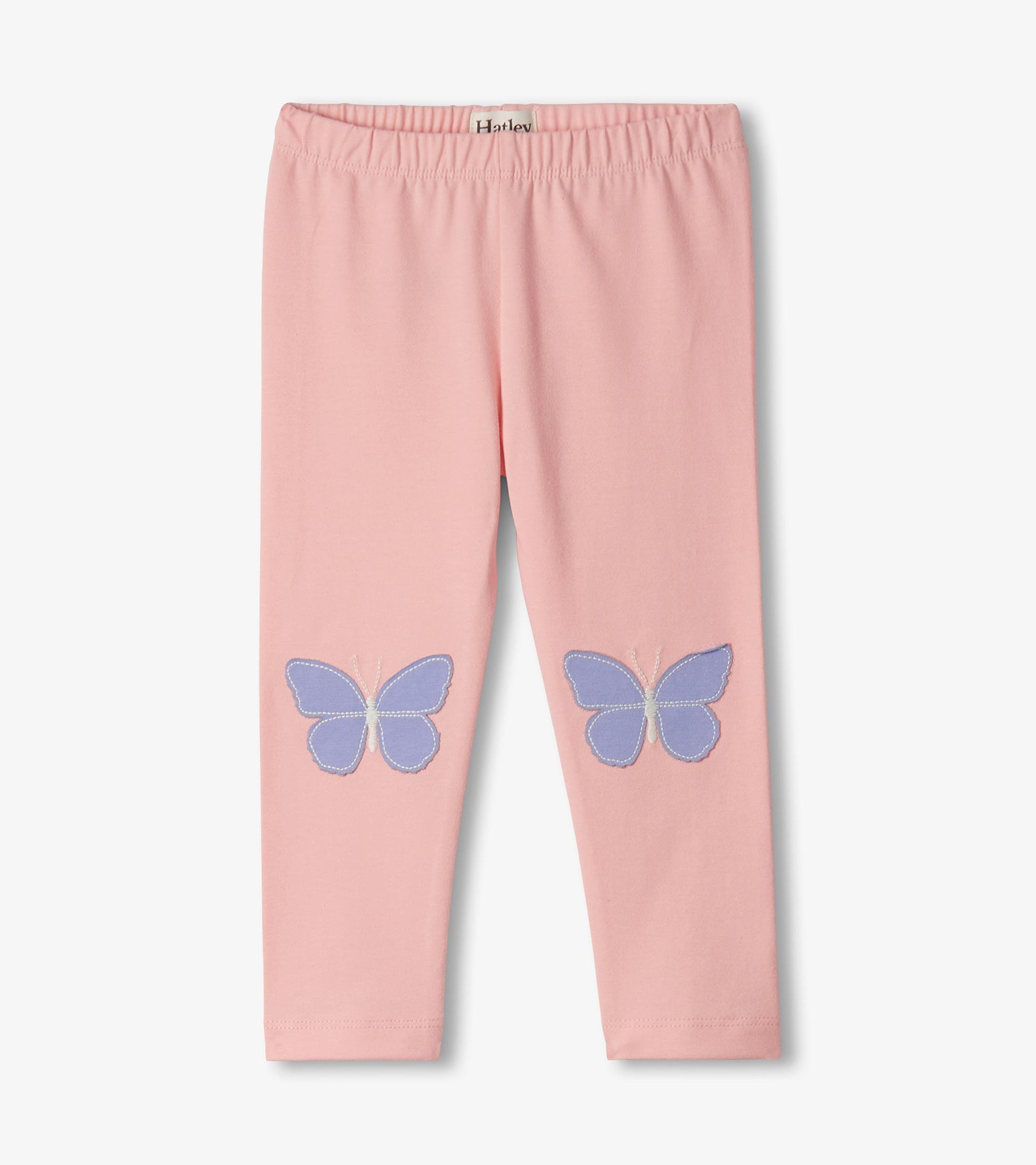 Pink toddler leggings with purple butterfly patches on the knees, front view