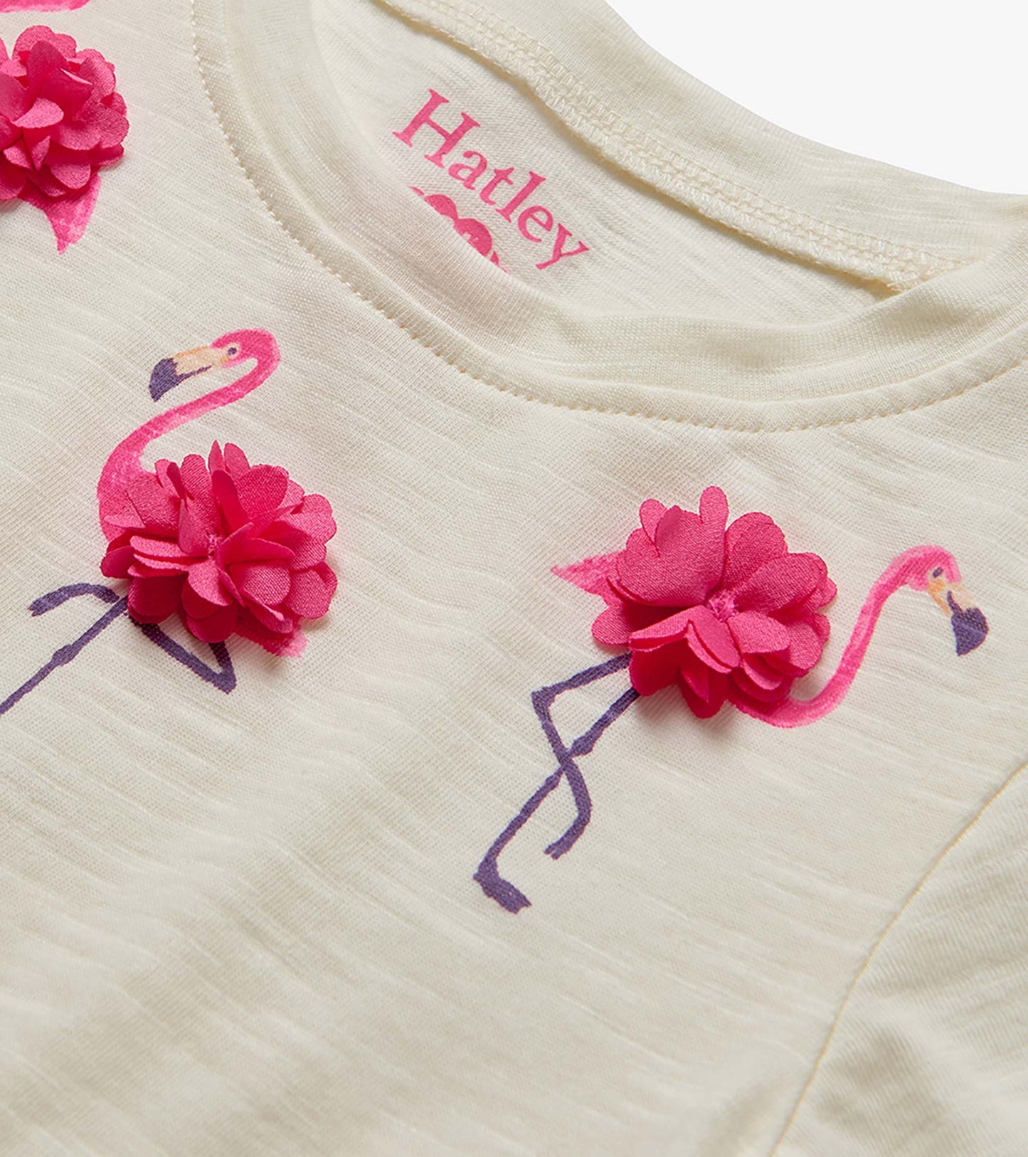 Cream toddler T-shirt with pink flamingo print and 3D flower appliqués, close-up front view