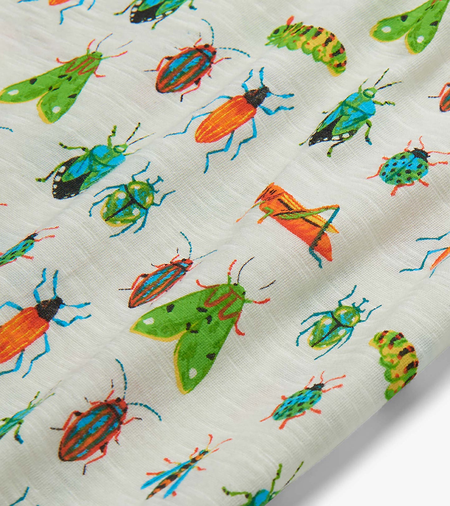 Close-up of white fabric with colorful insect print featuring beetles, moths, and grasshoppers
