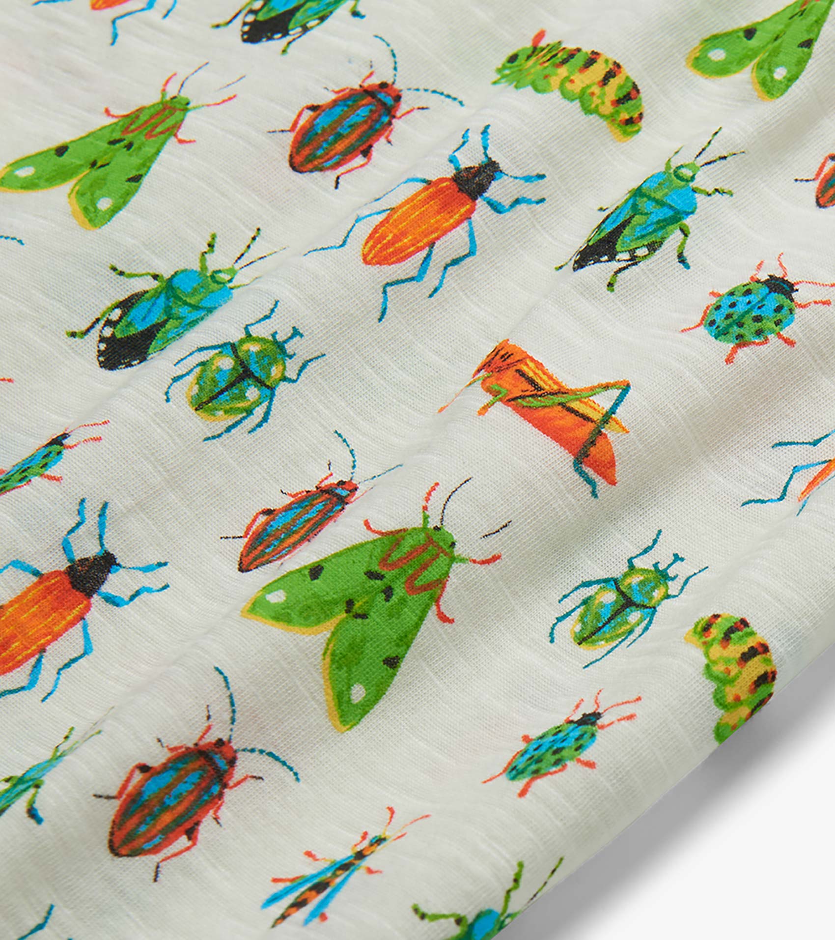 Close-up of white fabric with colorful insect print featuring beetles, moths, and grasshoppers