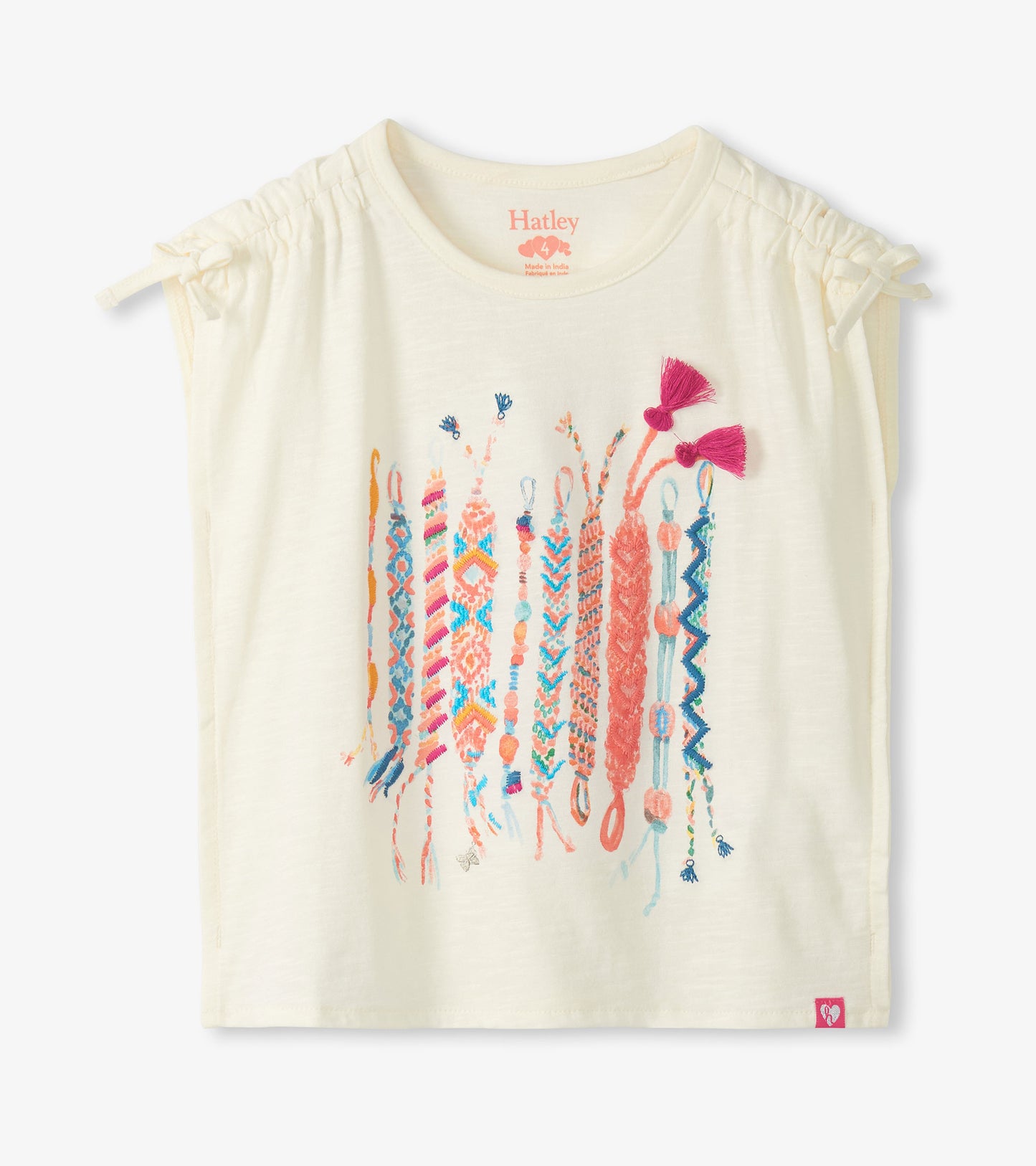Cream short-sleeve girls top with cinched shoulders and colorful friendship bracelet graphic on the front