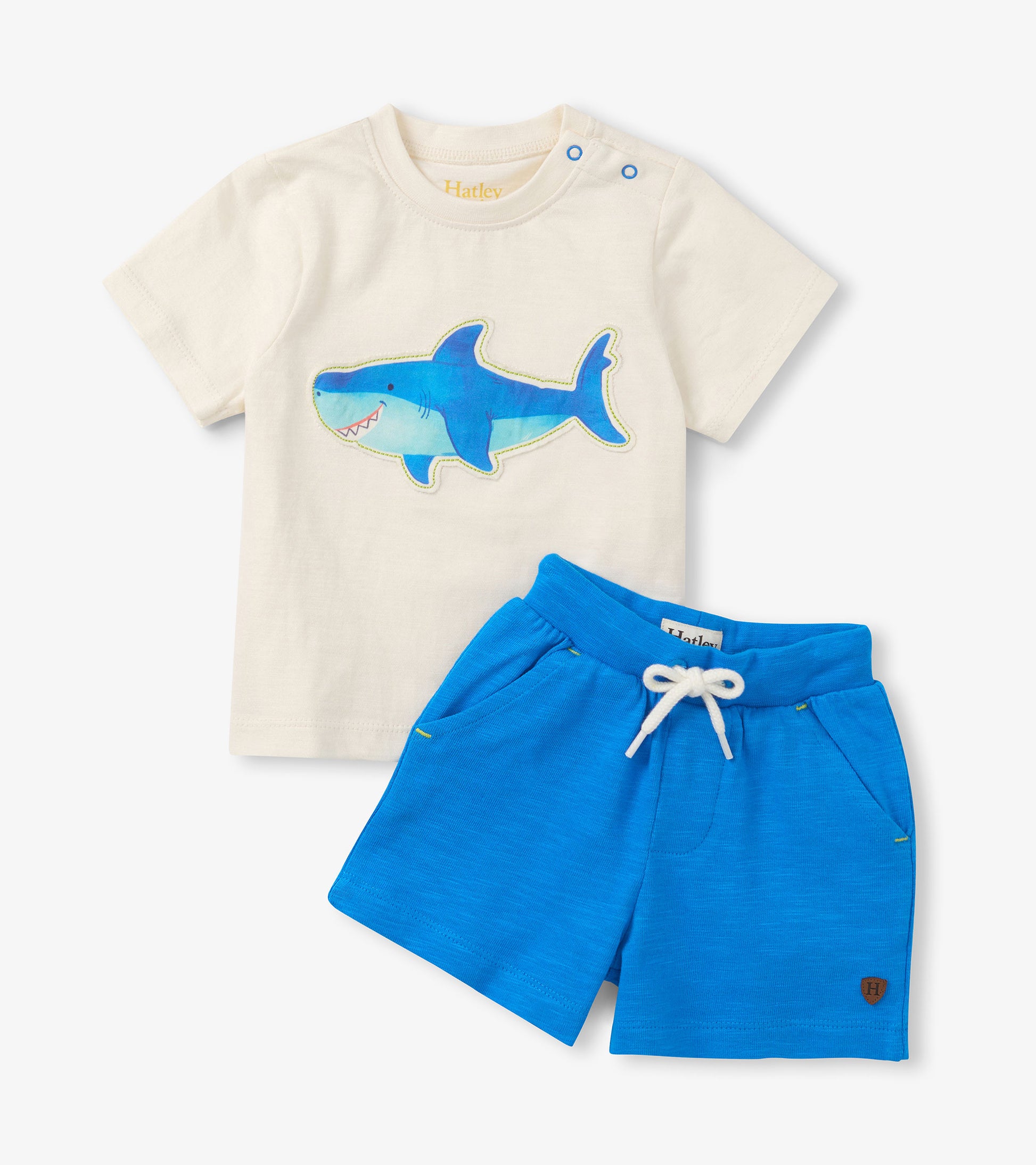 Cream short-sleeve T-shirt with blue shark graphic and bright blue drawstring shorts set, front view