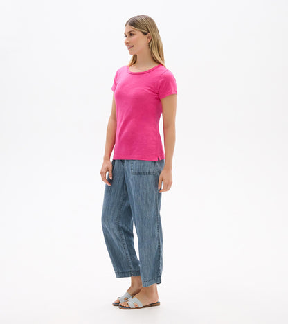 Women's bright pink crew neck short sleeve tee shown from the front on a model