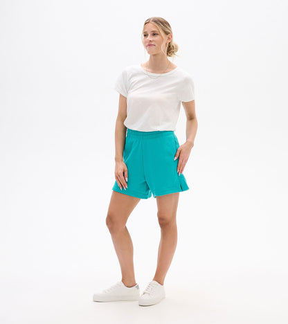 Turquoise high-waisted shorts with elastic waistband and cuffed hems, shown on a model front view.