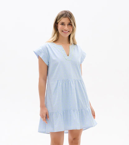 Front view of blue and white striped dress with neon dots, split neckline, cap sleeves, and tiered hem