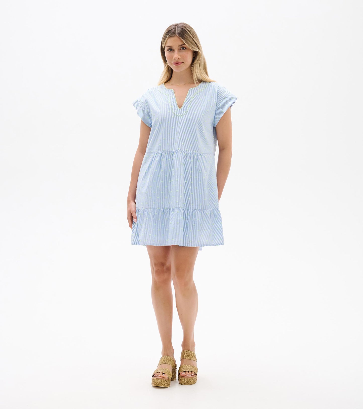 Front full-length view of blue and white striped dress with neon dots, cap sleeves, and tiered hem