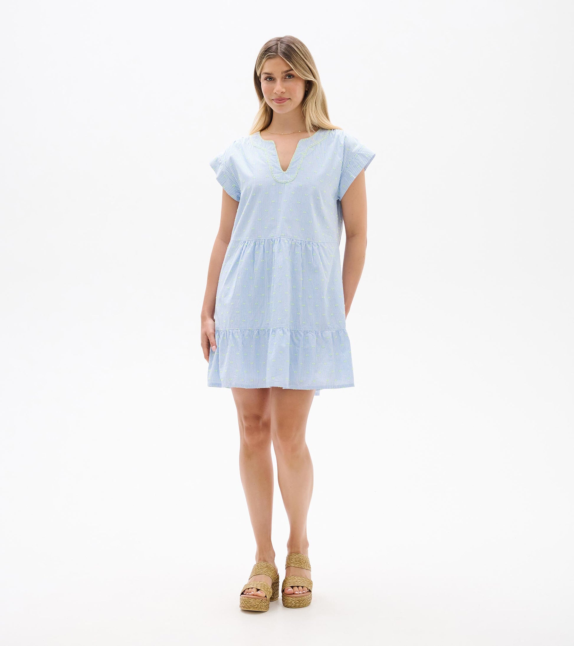Front full-length view of blue and white striped dress with neon dots, cap sleeves, and tiered hem
