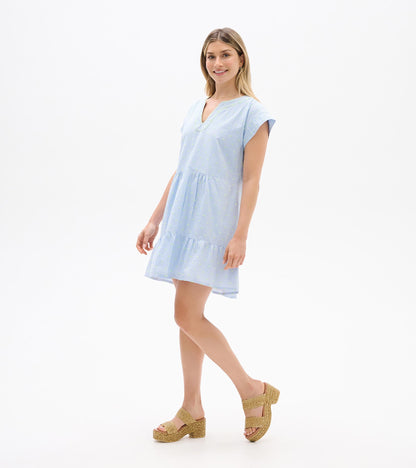 Angled front view of blue and white striped dress with neon dots, split neckline, and tiered skirt
