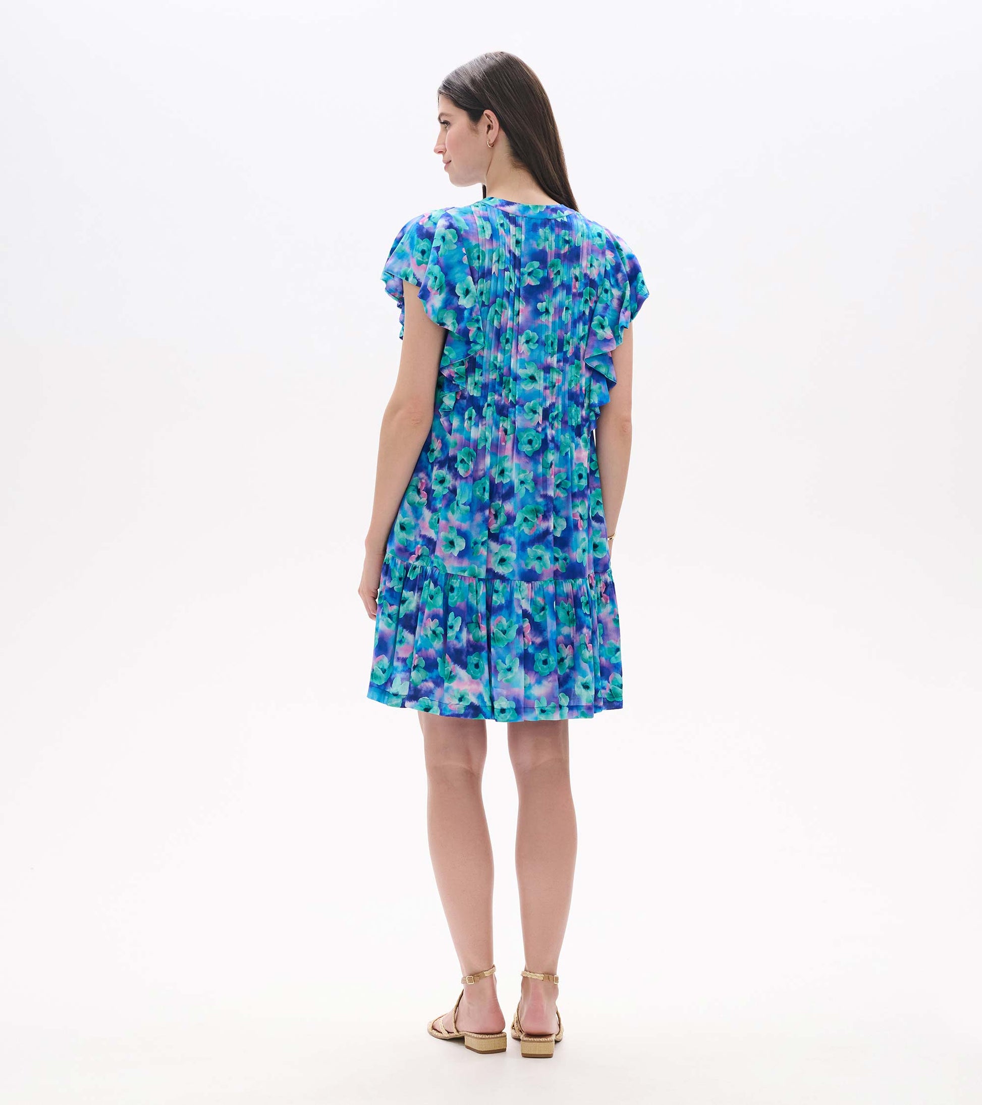 Back view of Floating Flowers pintuck dress with blue and purple floral print and flutter sleeves