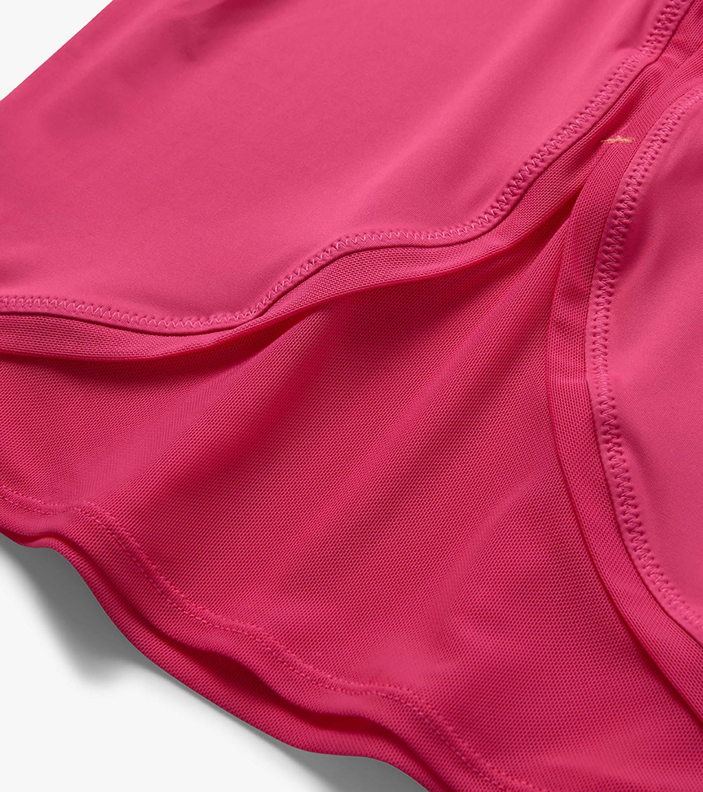 Close-up of a pink girls' T-shirt with mesh trim and curved stitched seams