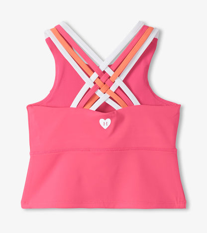 Pink girls active tank top with crisscross multicolor straps and small heart logo, front view