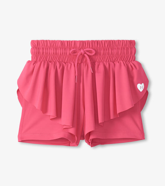Pink girls running shorts with ruffled overlay, elastic waistband, and drawstring front view