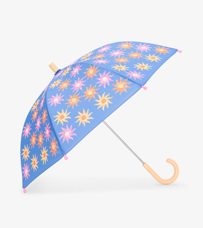 Open kids umbrella with blue canopy, pink orange and yellow sun print, pink tips, and curved wooden handle