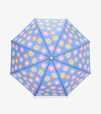 Blue umbrella with pink, yellow, and orange sunburst pattern, top view