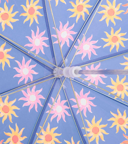 Blue umbrella canopy with pink and yellow sun pattern and silver spokes, close-up view