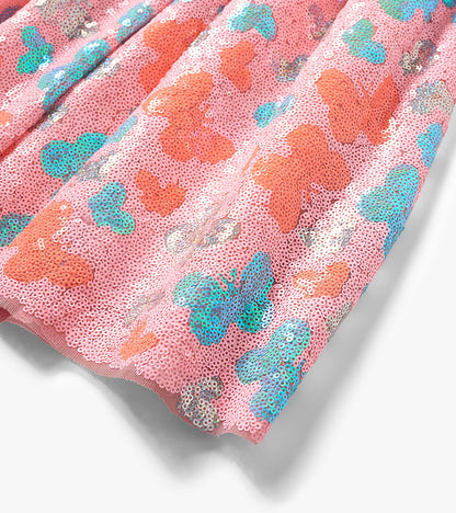 Pink sequin skirt with colorful butterfly pattern, shown folded close-up