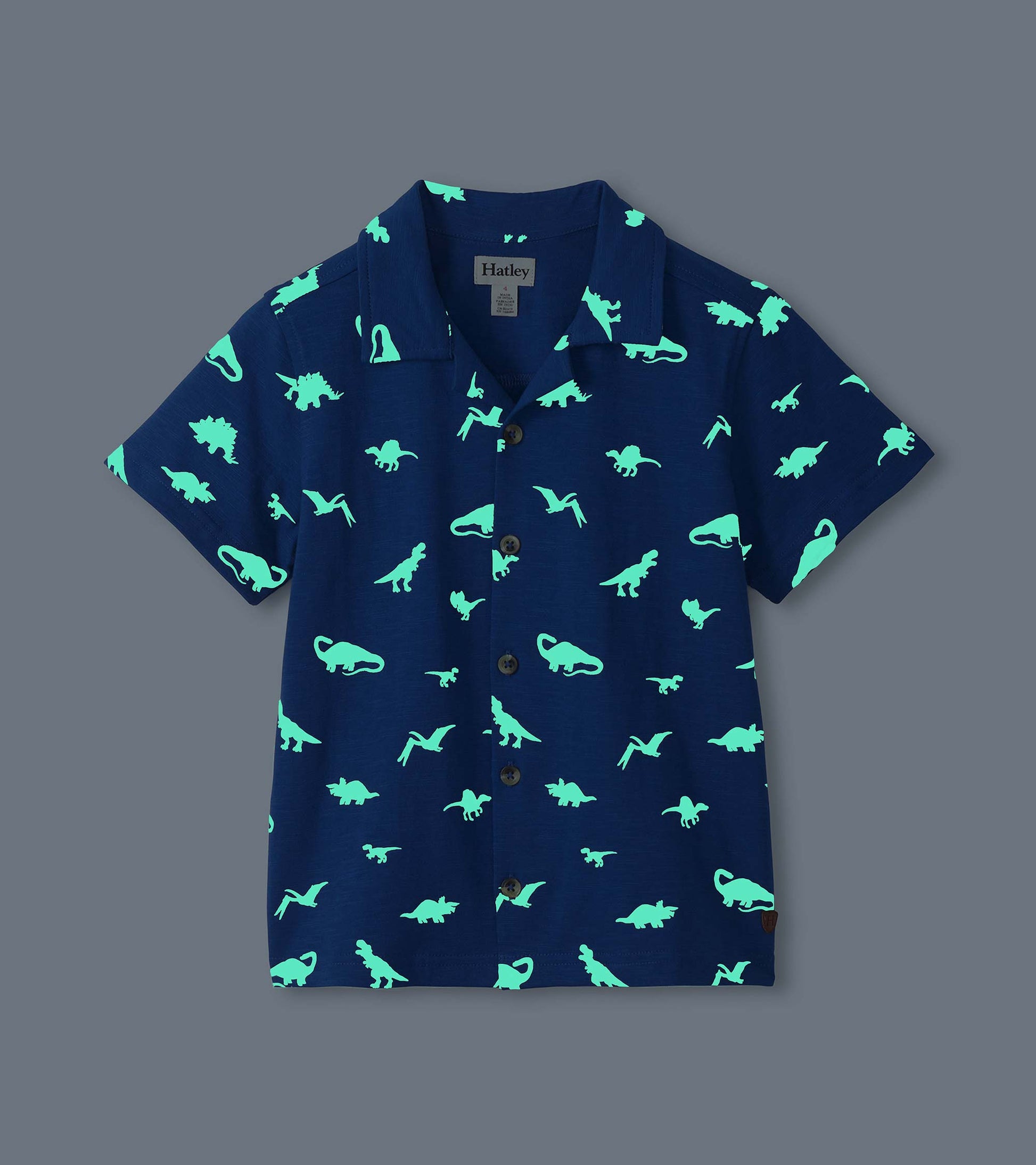 Navy short-sleeve button-down shirt with glowing mint dinosaur print, front view