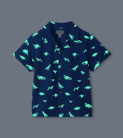 Navy short-sleeve button-down shirt with glowing mint dinosaur print, front view