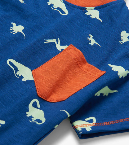 Blue toddler T-shirt with white dinosaur print and orange chest pocket, close-up view
