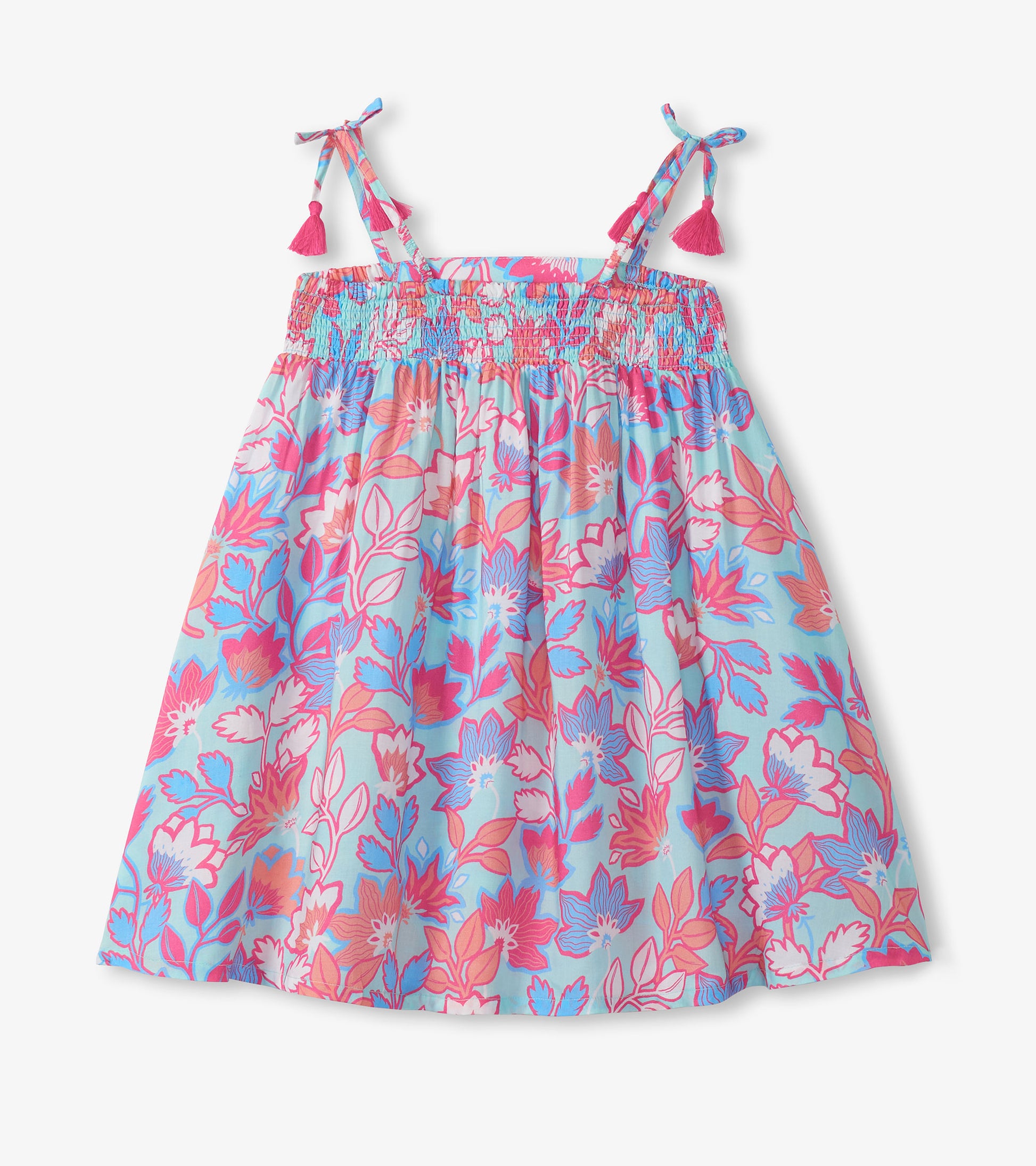 Girls floral smocked sundress with tie shoulder straps and pink tassels, blue background, front view