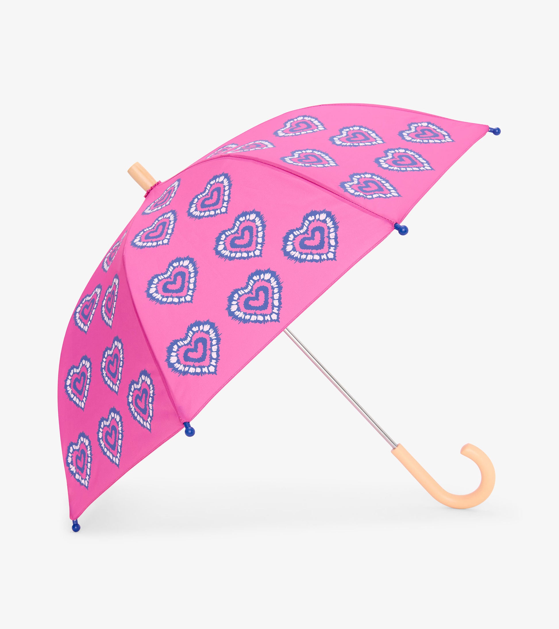 Pink kids umbrella with blue heart pattern, peach handle, and curved hook handle on white background