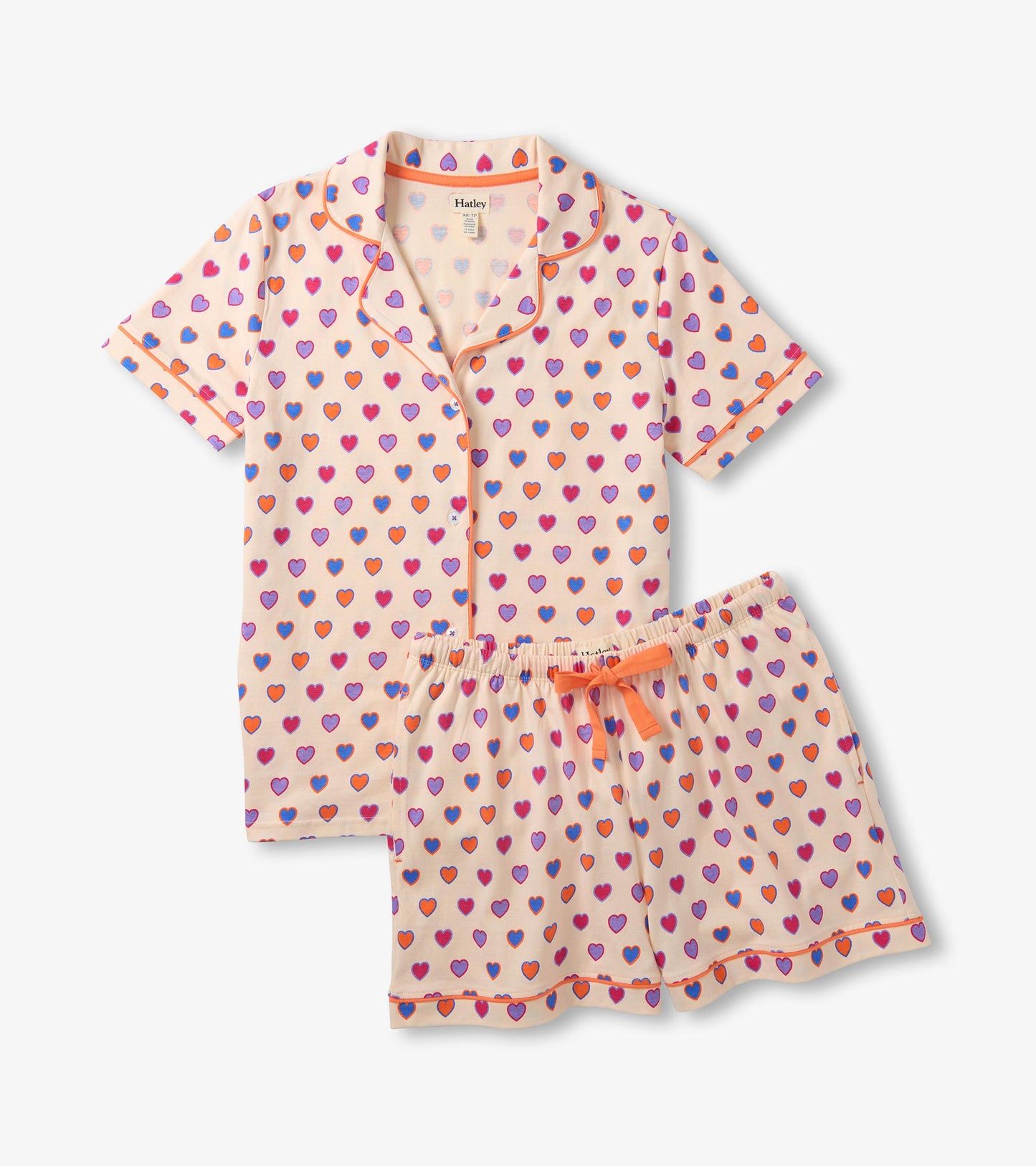 Short-sleeve button-up pajama set with shorts, cream fabric, and multicolor heart print