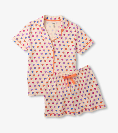 Short-sleeve button-up pajama set with shorts, cream fabric, and multicolor heart print