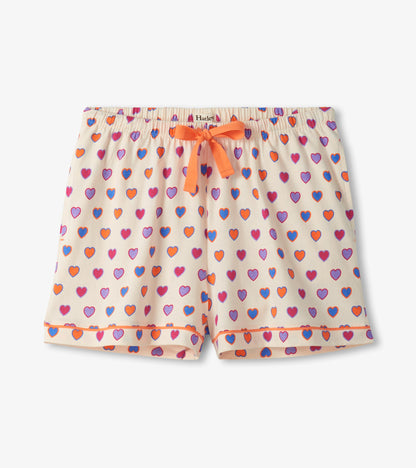 Cream pajama shorts with multicolor heart print and orange drawstring waistband, front view