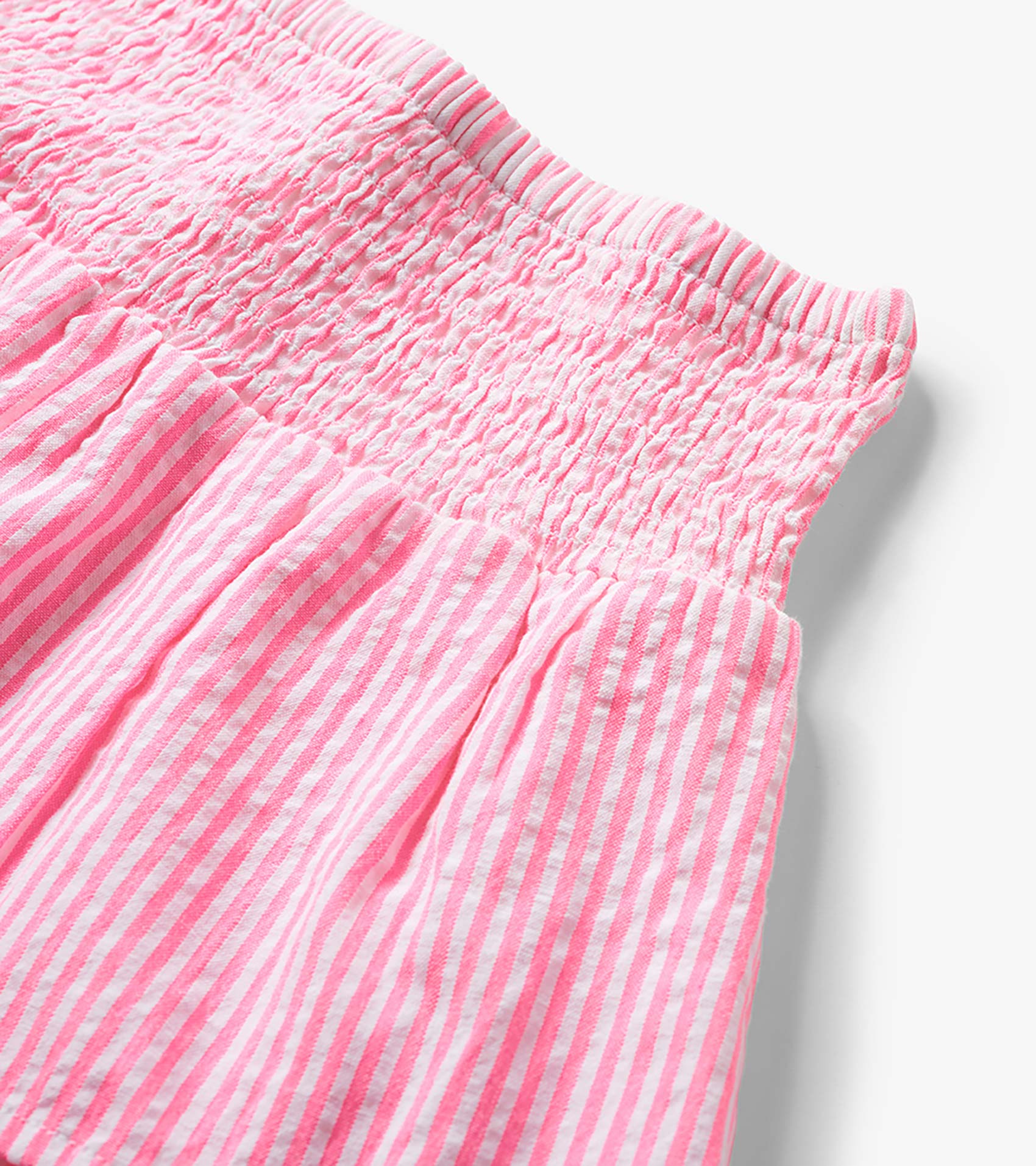 Neon pink and white striped seersucker skirt with smocked waistband and gathered fabric