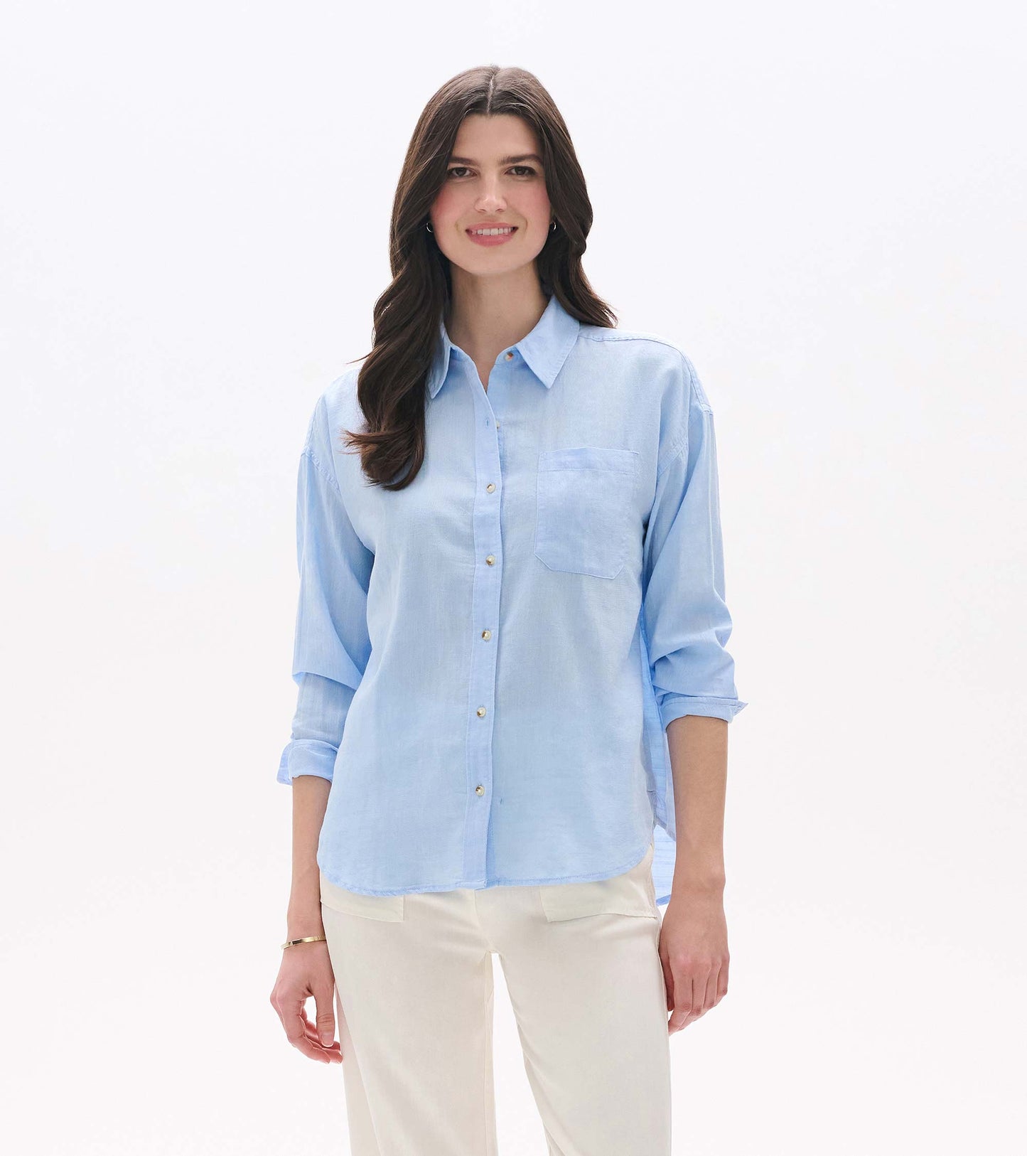 Light blue chambray button-down shirt with collar, chest pocket, and rolled sleeves, front view on model