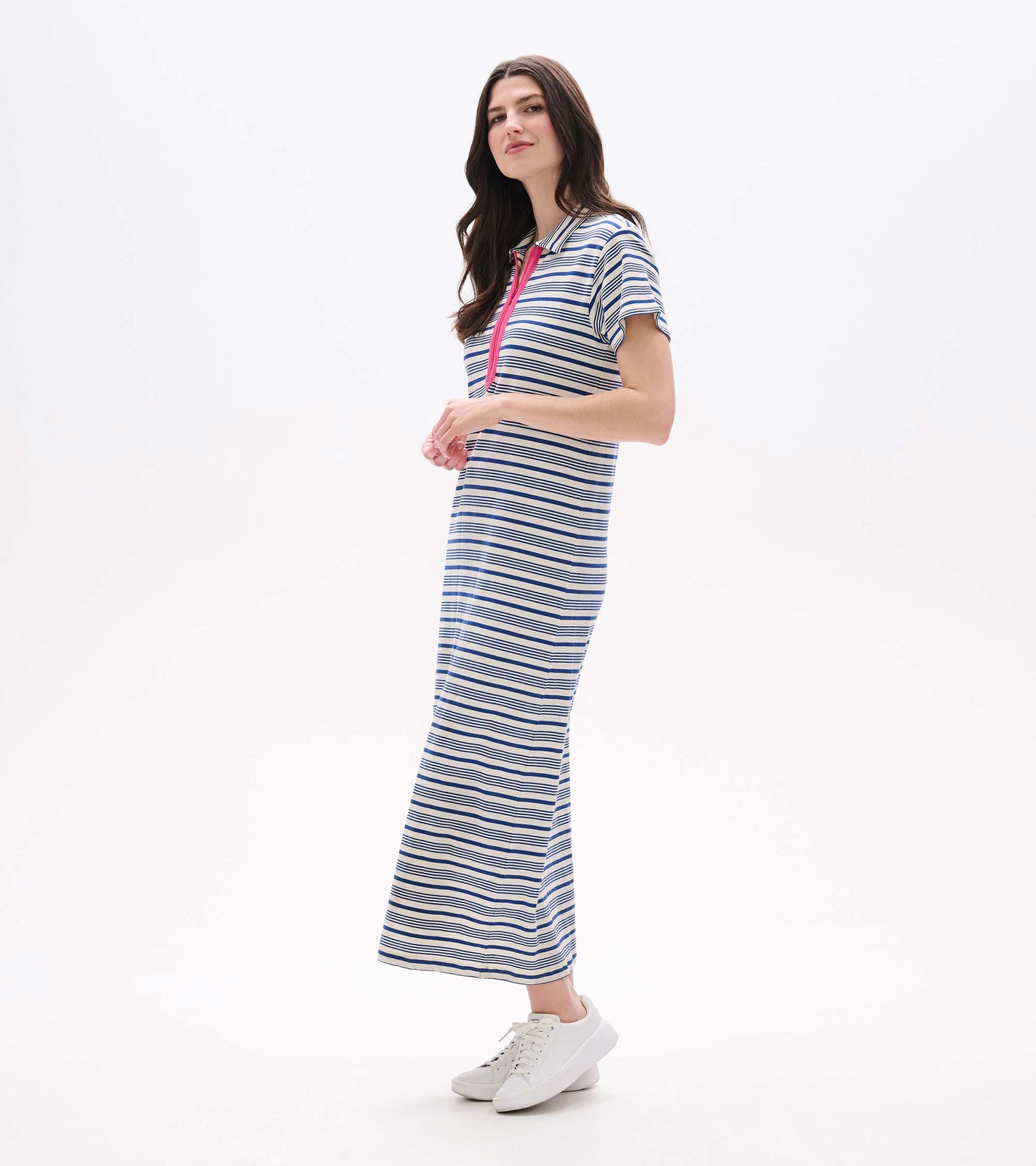 Woman wearing a blue-and-white striped maxi dress with pink zip detail and short sleeves, front view.