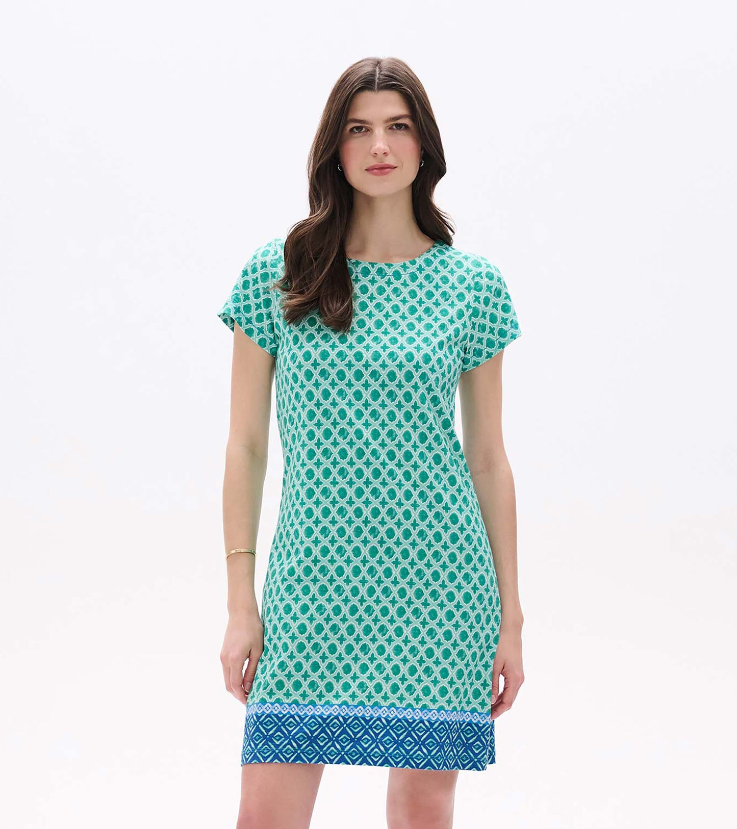 Front view of green printed tee dress with short sleeves and blue patterned border hem