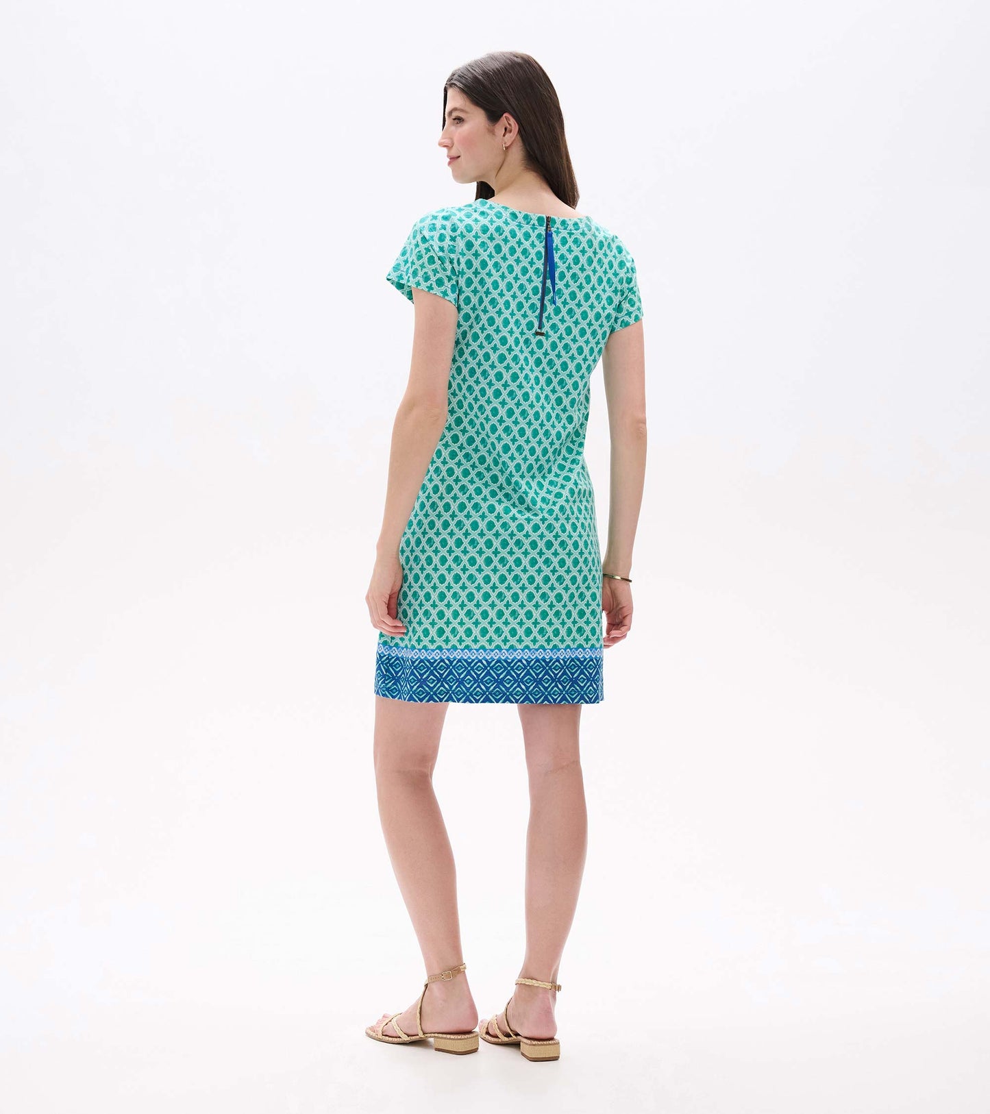 Back view of green printed tee dress with short sleeves, blue border hem, and visible back zipper