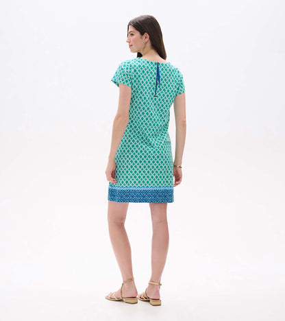 Back view of green printed tee dress with short sleeves, blue border hem, and visible back zipper