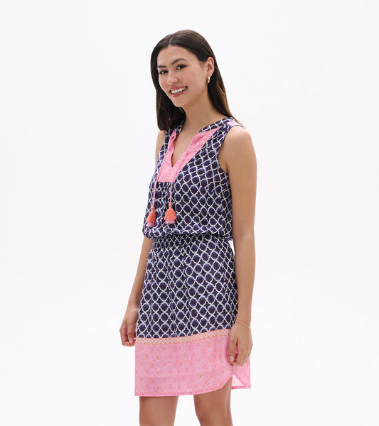 Sleeveless navy and pink patterned dress with tassel ties, shown on model front view