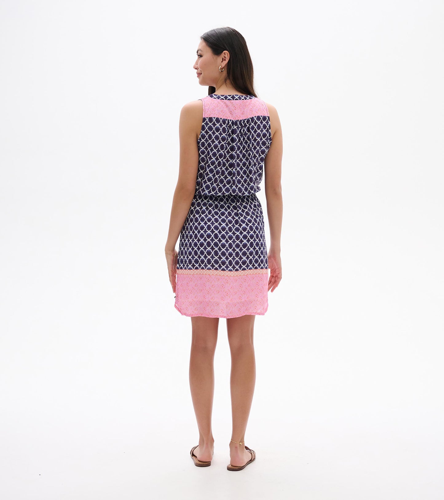 Sleeveless navy and pink patterned dress, back view, with knee-length hem and waist tie.