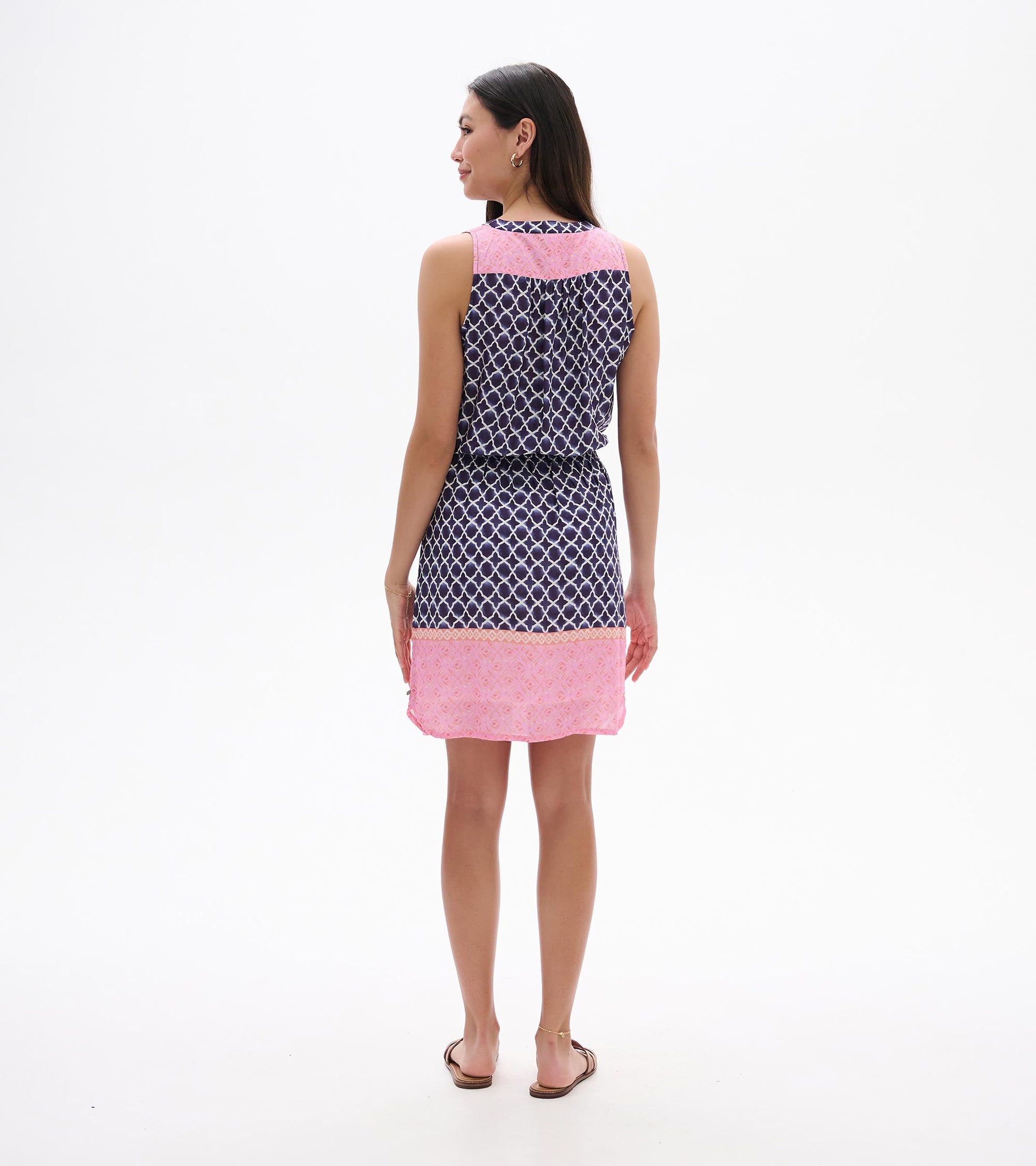 Sleeveless navy and pink patterned dress, back view, with knee-length hem and waist tie.